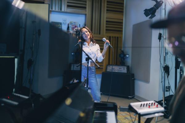 AMANDA SHIRES singing while piano accompanies her in studio